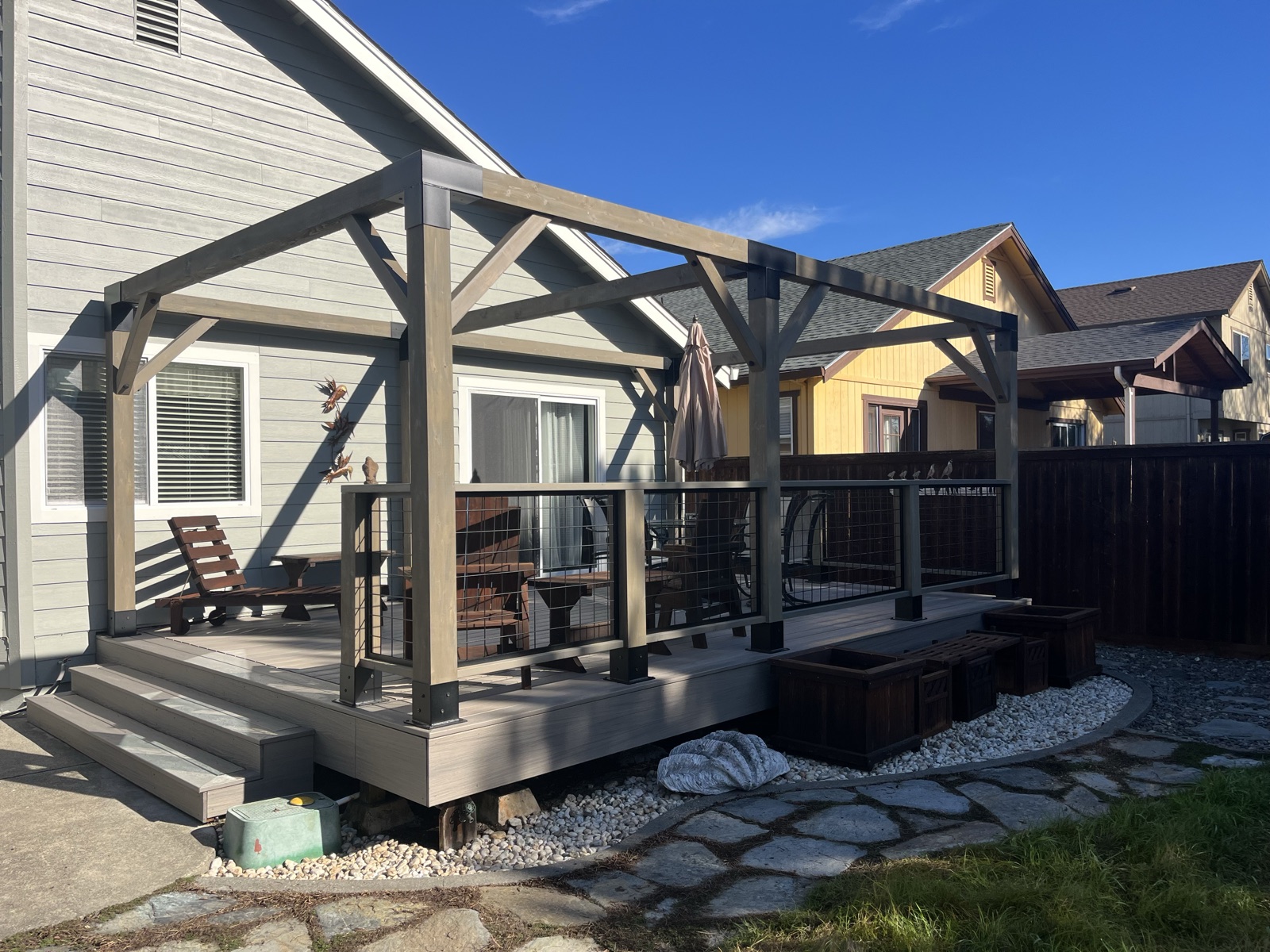 Custom composite deck with timber-frame covered pergola and cable railing — Soulié Construction, Sonoma County