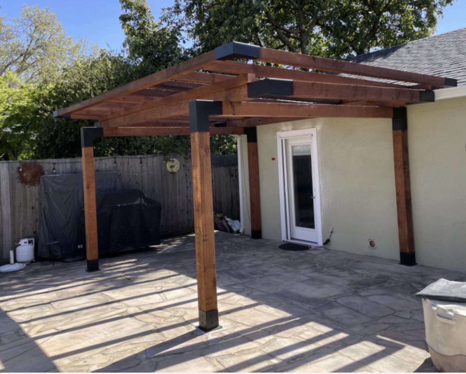Redwood pergola and built-in BBQ over a stamped-concrete patio in Sonoma County by Soulié Construction